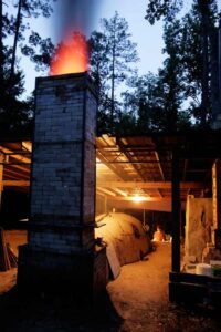 Strong flame out of the chimney, witches cap